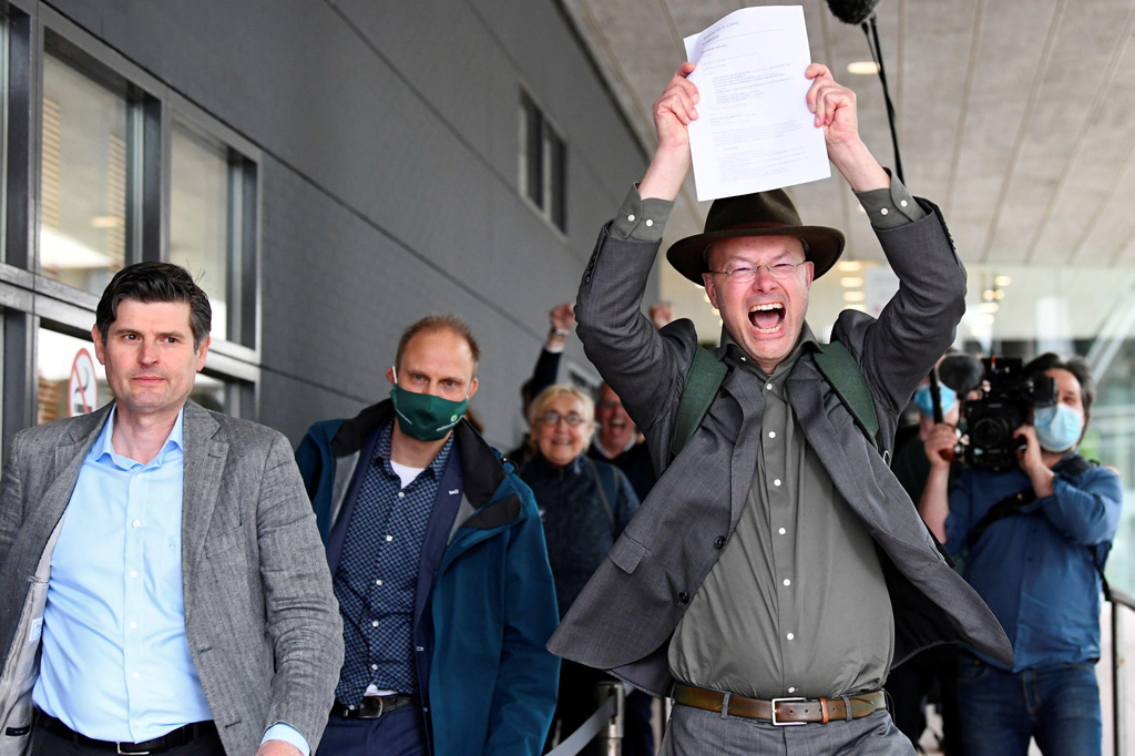Donald Pols, Director of Friends of the Earth, holding a copy of a verdict in a case brought on against Shell by environmentalist and human rights groups