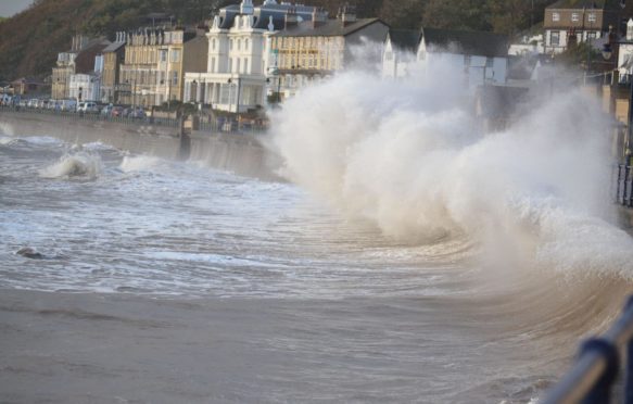 Waves crashing into sea wall, Filey Bay, Yorkshire