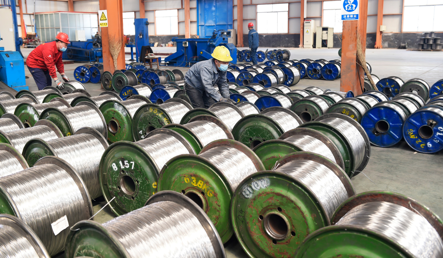 Workers are engaged in aluminium cable production, in Zouping County