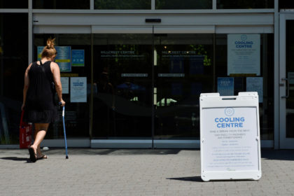 A woman enters a cooling centre during the scorching weather of a heatwave in Vancouver