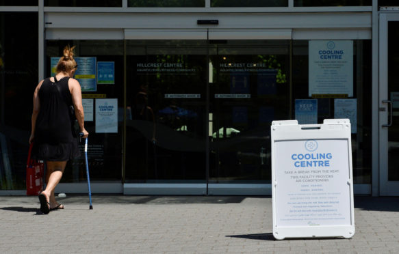 A woman enters a cooling centre during the scorching weather of a heatwave in Vancouver