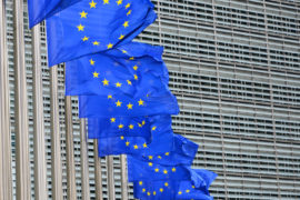 Row of billowing blue European Union flags outside the EU headquarters Berlaymont building