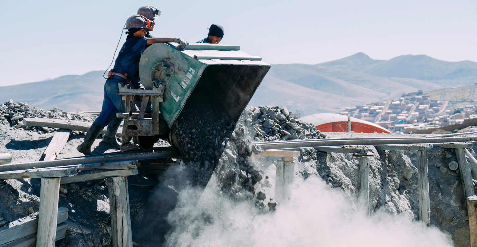 Workers dumping coal at a construction site