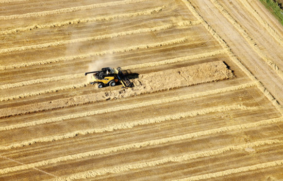 An aerial view of farm machinery in the field harvesting wheat Idaho_EN9MDW