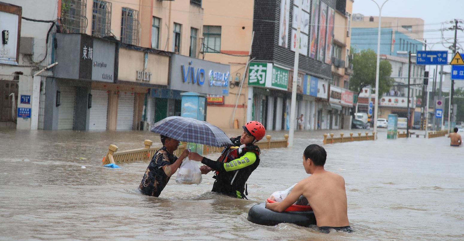 Firefighters help citizens with their vehicles and safety as Typhoon In-fa brings heavy rains and flooding in Ningbo City_2GA6GHR