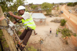 Workers-string-new-power-cables-in-a-rural-village-near-Dodoma,-Tanzania,-East-Africa-Image ID: FA4P68