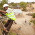 Workers-string-new-power-cables-in-a-rural-village-near-Dodoma,-Tanzania,-East-Africa-Image ID: FA4P68