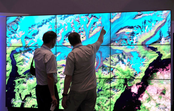 European space scientists view NASA data visualizations at the US Center during COP 18 Doha