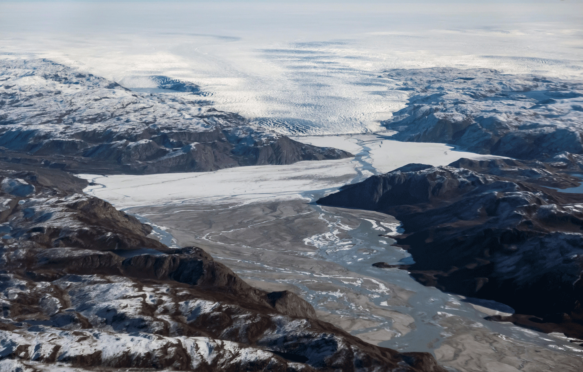 A glacier at the edge of the ice sheet, melting water and mud are pictured in the North of Kangerlussuaq, Greenland