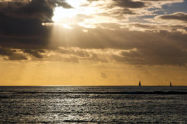 Afternoon clouds with sun rays over the Pacific ocean in Honolulu, Hawaii