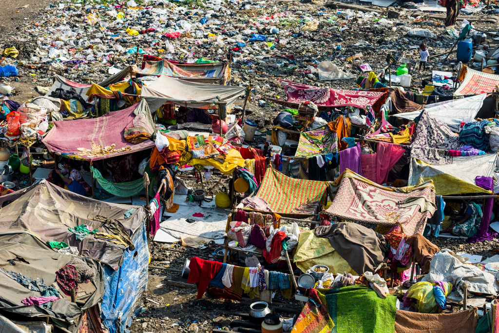 People living in huts made from iron sheets and blankets in Dharavi Slum, India