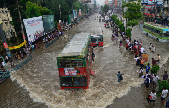 Vehicles try driving through the flooded Dhaka streets in Bangladesh_F1D308