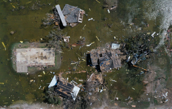 Homes and businesses destroyed by Hurricane Laura are surrounded by flood waters in the aftermath of Hurricane Delta in Louisiana, USA, 2020