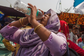 A woman drinks water during a hot day in New Delhi, April 29, 2022