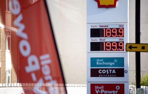 The price board at a shell Gas Station displays the unit prices of different gas in London