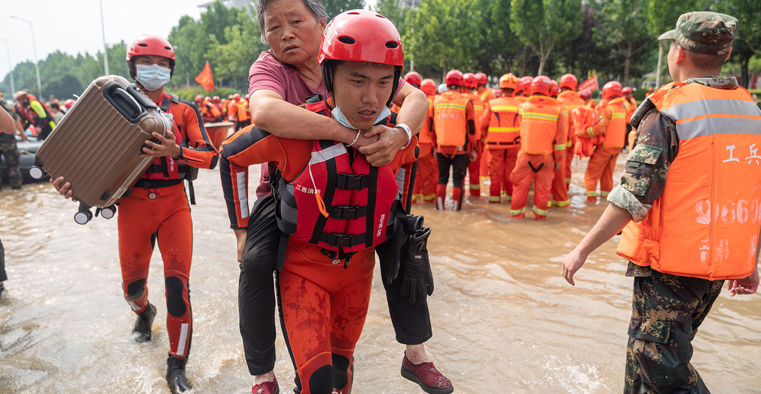 People are evacuated after heavy downpours in Zhengzhou, Henan, China, on 22 July 2021. Credit: Xinhua / Alamy Stock Photo. 2G8R652