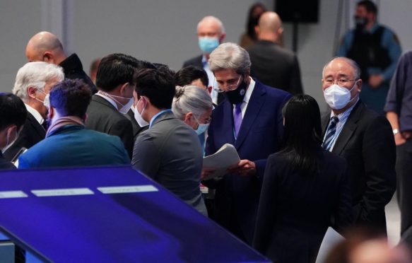 US Special Presidential Envoy for Climate John Kerry talks to delegates from China at COP26