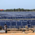 Workers install solar photovoltaic panels in Pakistan.