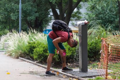 A young man refreshes himself at Giordano Bruno Square, City of Buenos Aires, during the January 2022 heat wave in Argentina.