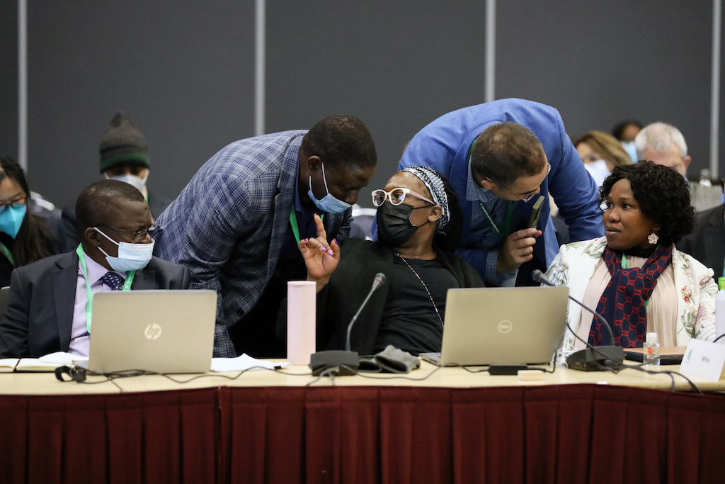 Delegates conferring during a contact group on targets of the draft global biodiversity framework (GBF), 4 December 2022.