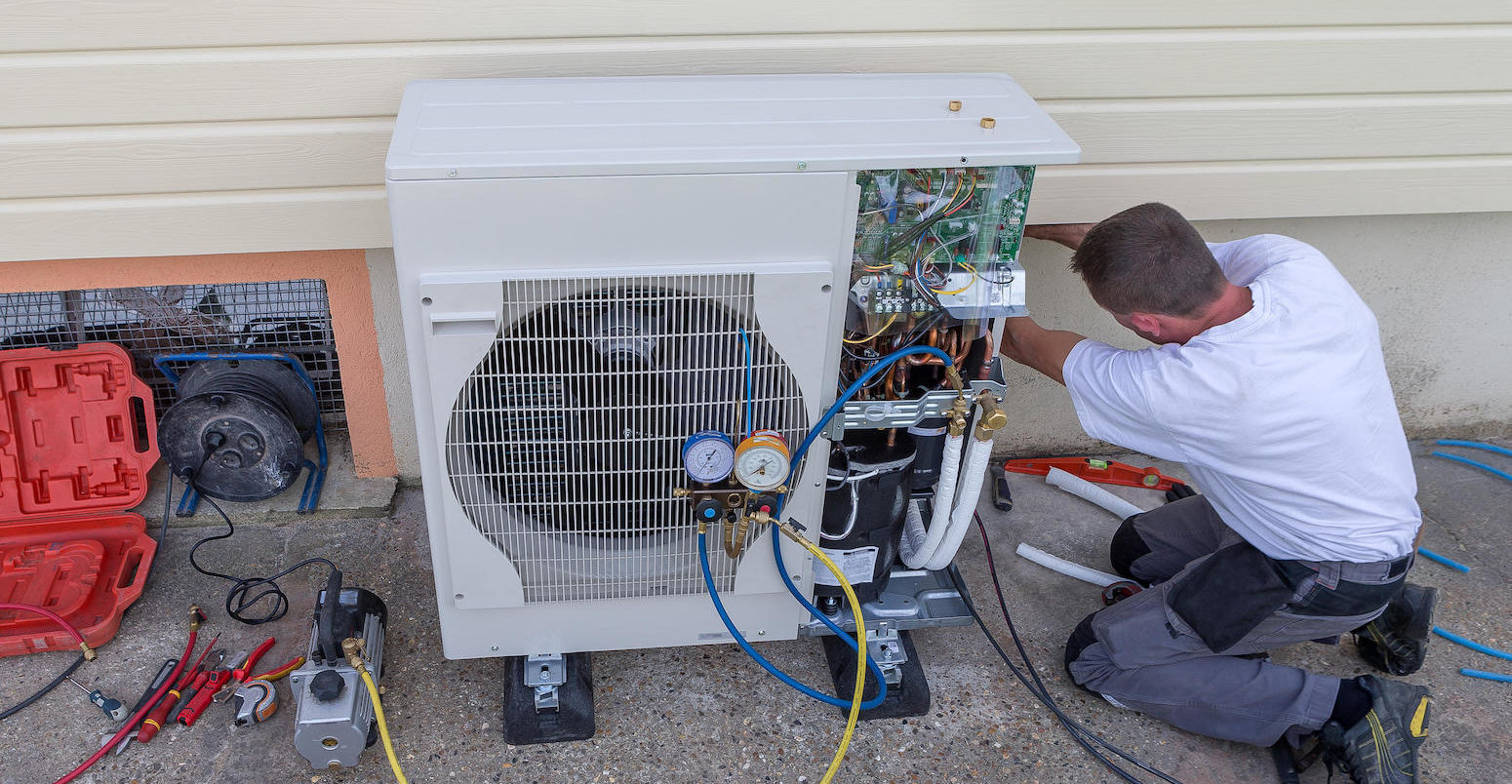 Plumber installing a heat pump.