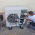 Plumber installing a heat pump.