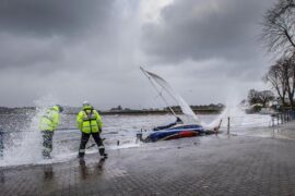 Yacht washed ashore and grounded during Storm Ciara at Cardwell Bay, Gourock, UK with H M Coastguard in attendance