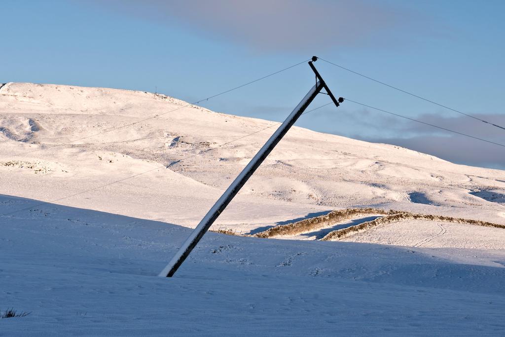 Damage to overhead cables and a pole after Storm Arwen, November 2021, Settle, North Yorkshire, UK.