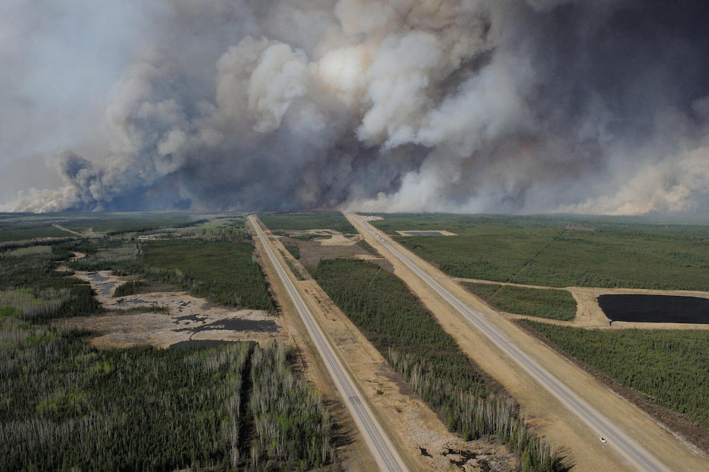 An aerial view of Highway 63, during a mandatory evacuation that had been placed on all of Fort McMurray, Canada. Image ID: W0MP8P.