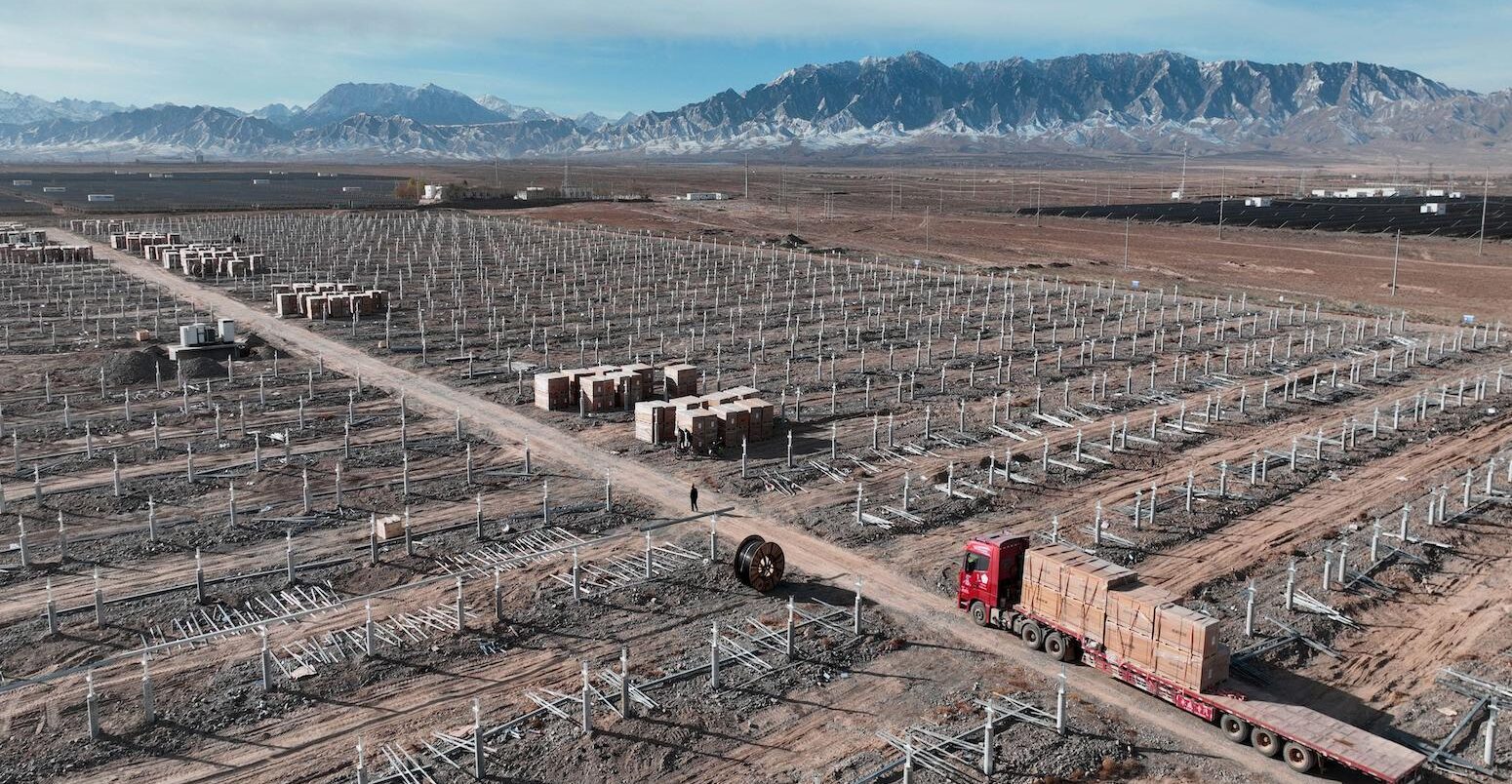 Workers speed up installation of photovoltaic panels at the construction site of the solar power generation project in Zhangye, China.