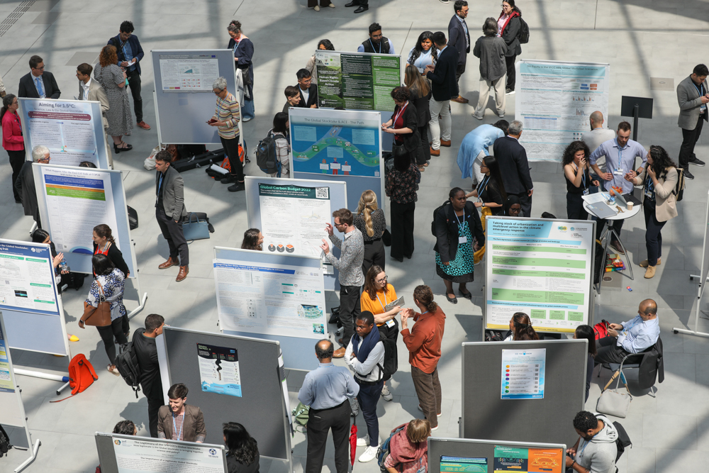 Delegates visit a poster session to share information about the GST, 7 June 2023. Credit: Photo by IISD/ENB | Kiara Worth.