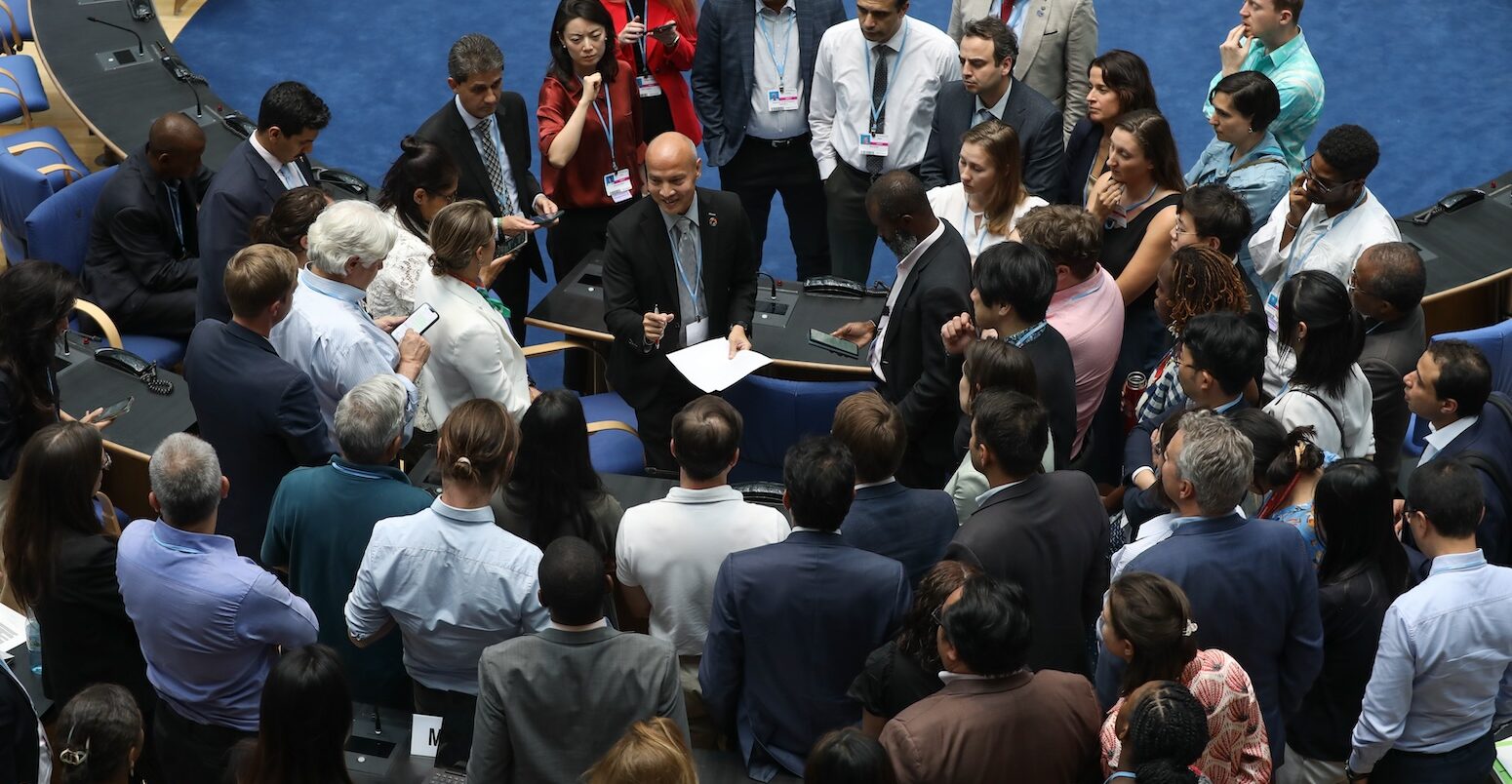 Delegates huddle during the contact group on the Global Stocktake, 14 June 2023. Credit: Photo by IISD/ENB | Kiara Worth.