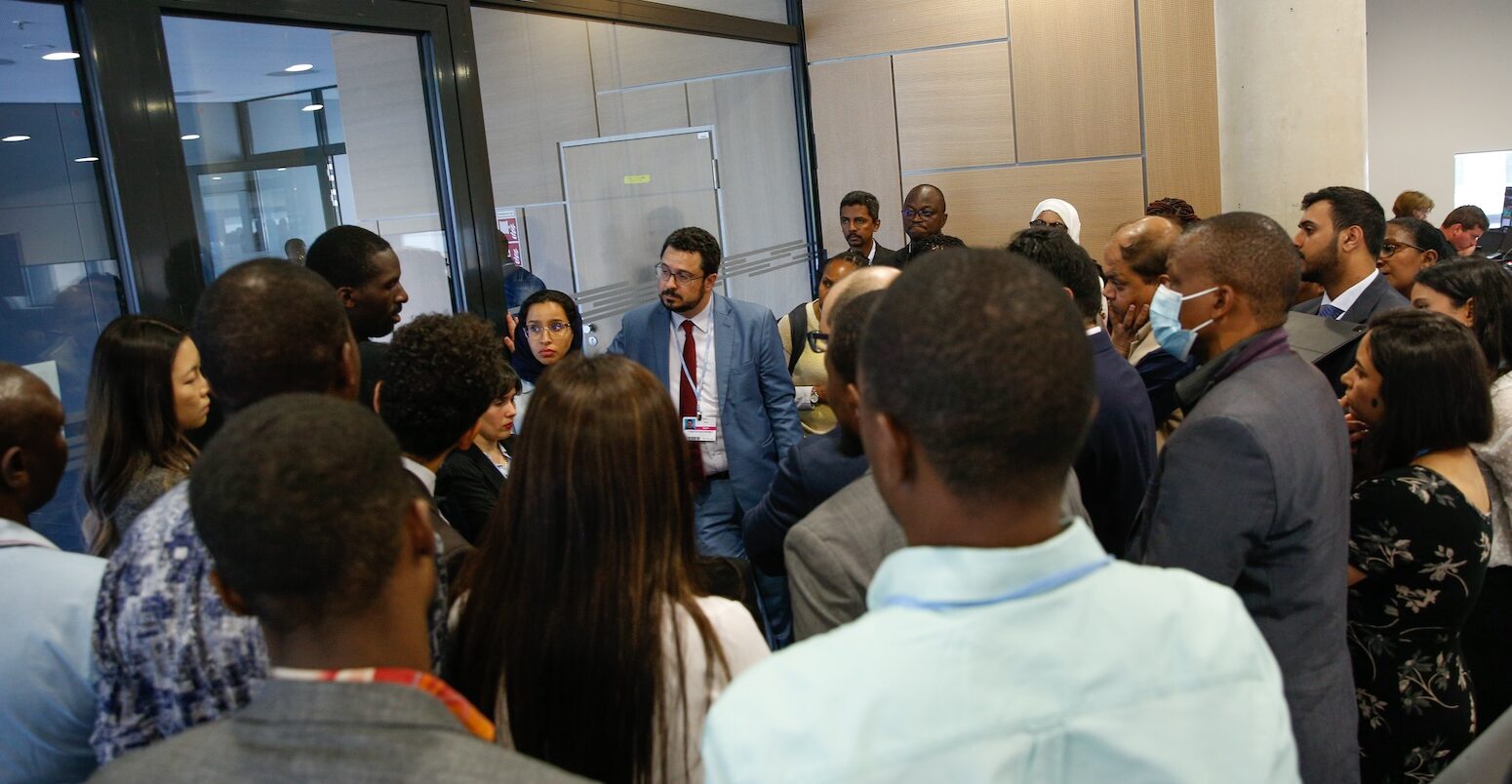 Delegates huddle during the informal consultations on financial and technical support, 15 June 2023. Credit: Photo by IISD/ENB | Kiara Worth.