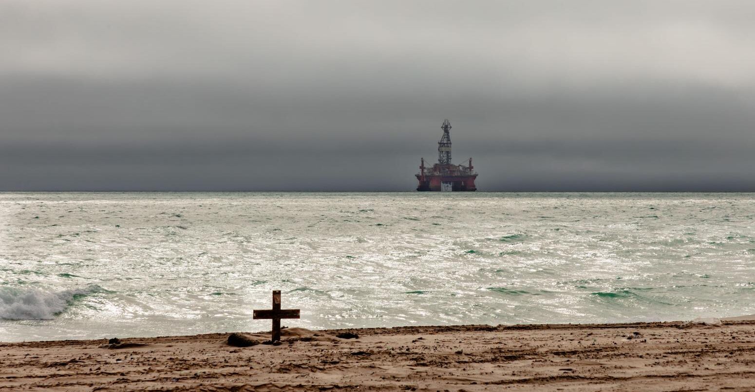 An oil rig looms amid threatening skies over the Atlantic Ocean off the coast of Namibia.