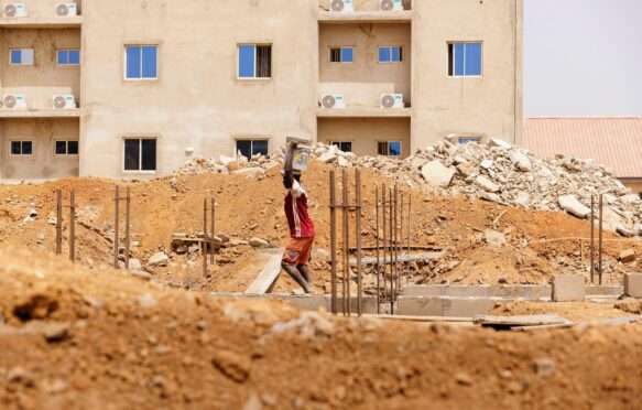 Young man works on a construction site in Nigeria on 6 February 2024.