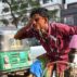 A rickshaw driver washing his face with water during a hot day in Dhaka, Bangladesh, on 15 April 2024.