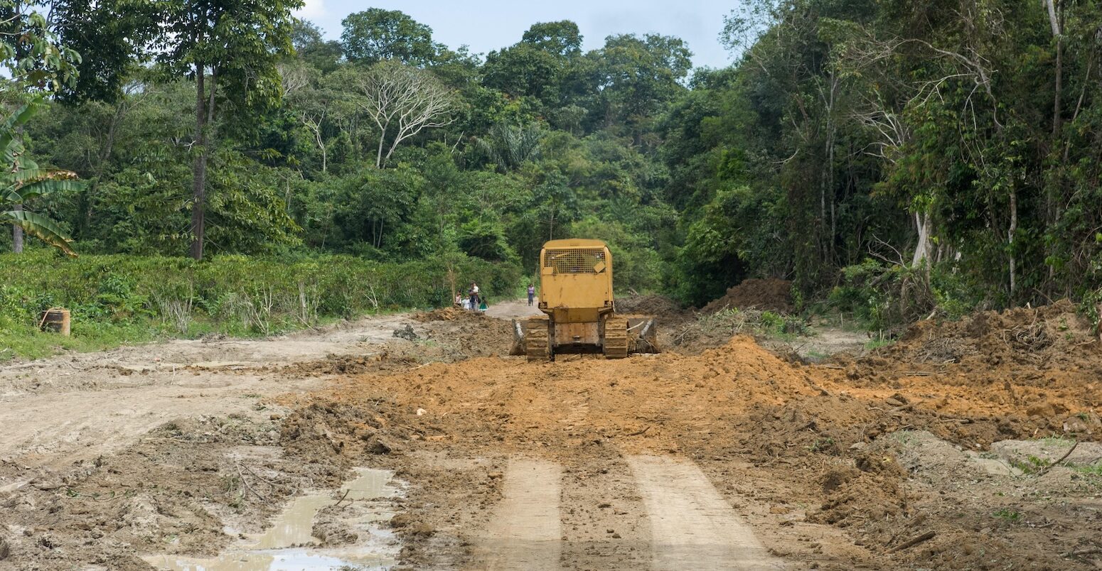 Bulldozer clears a dirt road in the Amazon near the Tapajos River in Para State, Brazil.