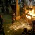 Workers racking the blast furnace in a foundry.