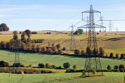 Pylons striding across the Cotswold countryside near Gloucestershire.