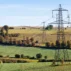 Pylons striding across the Cotswold countryside near Gloucestershire.