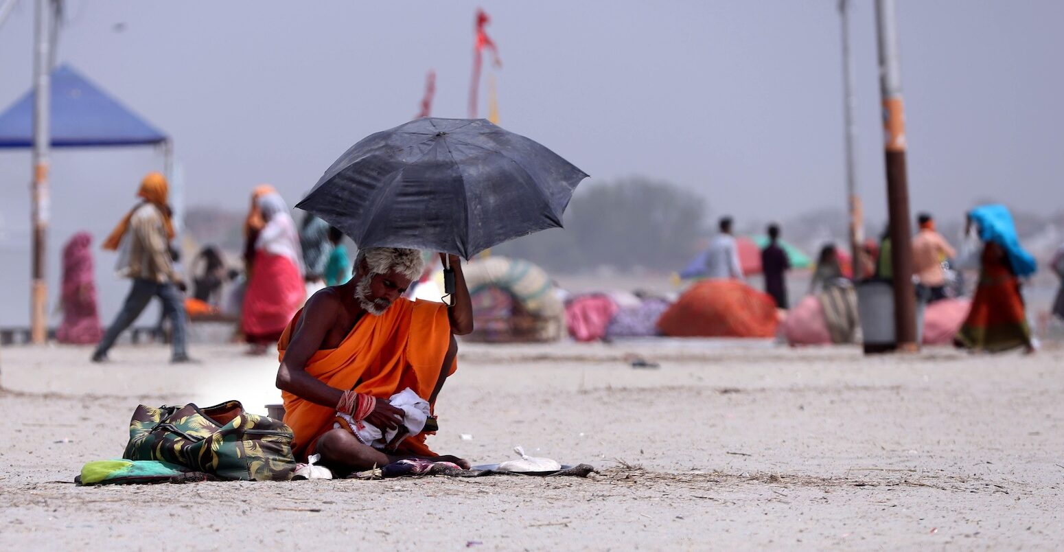 People brave heat wave conditions during a hot summer day in Uttar Pradesh, India.