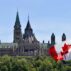 Canadian parliament buildings and Canada flag. Credit: Colin Clarke / Alamy Stock Photo. Image ID: WB161K.