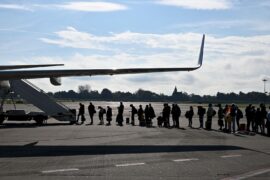 People waiting to get on a plane on the runway. Credit: SJBright / Alamy Stock Photo. Image ID: 2YRJ7J5.
