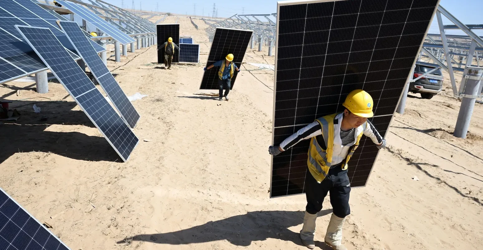 Workers install solar photovoltaic panels in Yinchuan, China.