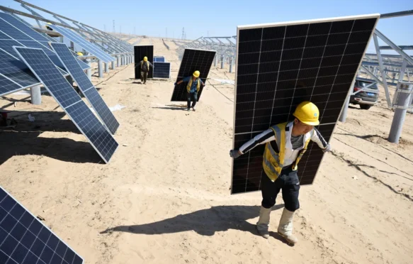 Workers install solar photovoltaic panels in Yinchuan, China.