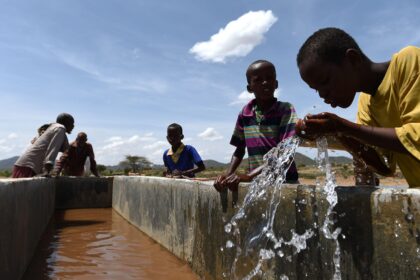 Children drink water from a pipeline in the village of Afraaga, Somaliland.
