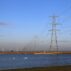 Pylons and wind farm in Dungeness, Kent, UK.