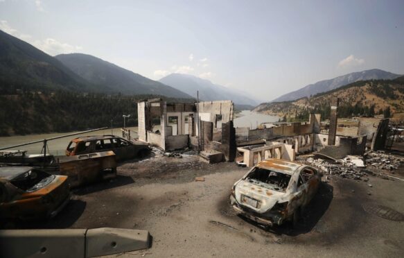 Damaged structures and vehicles after a wildfire destroyed most of the village, Lytton, B.C., Canada.
