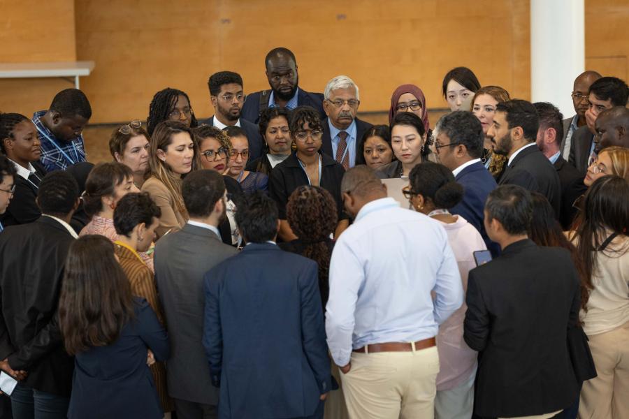 Members of the G-77/China huddle to find a way forward on the Global Goal on Adaptation (GGA)