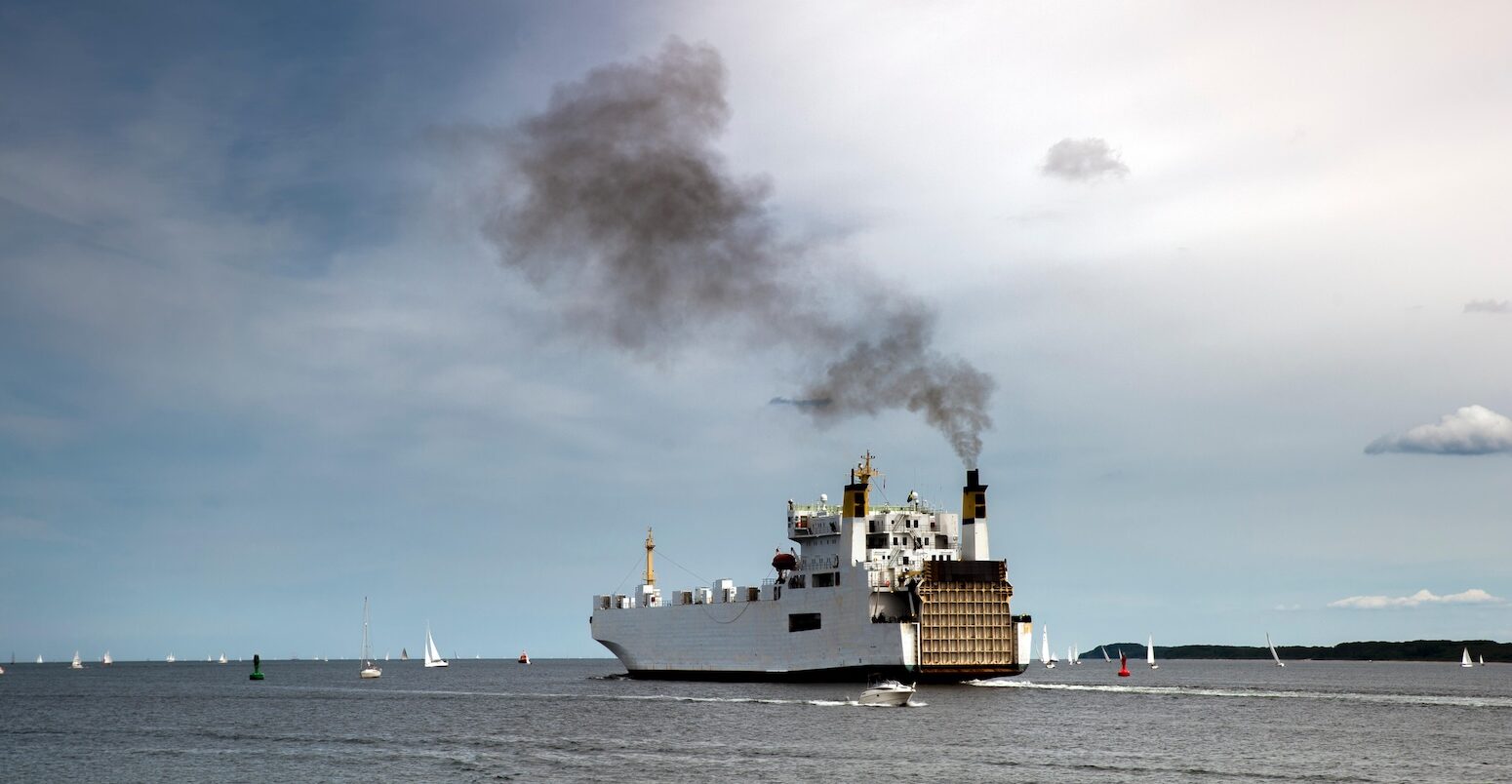 Ship emitting exhaust fumes.
